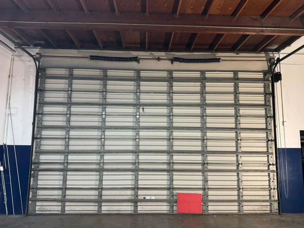 Commercial door and opener fitted for a working bay.